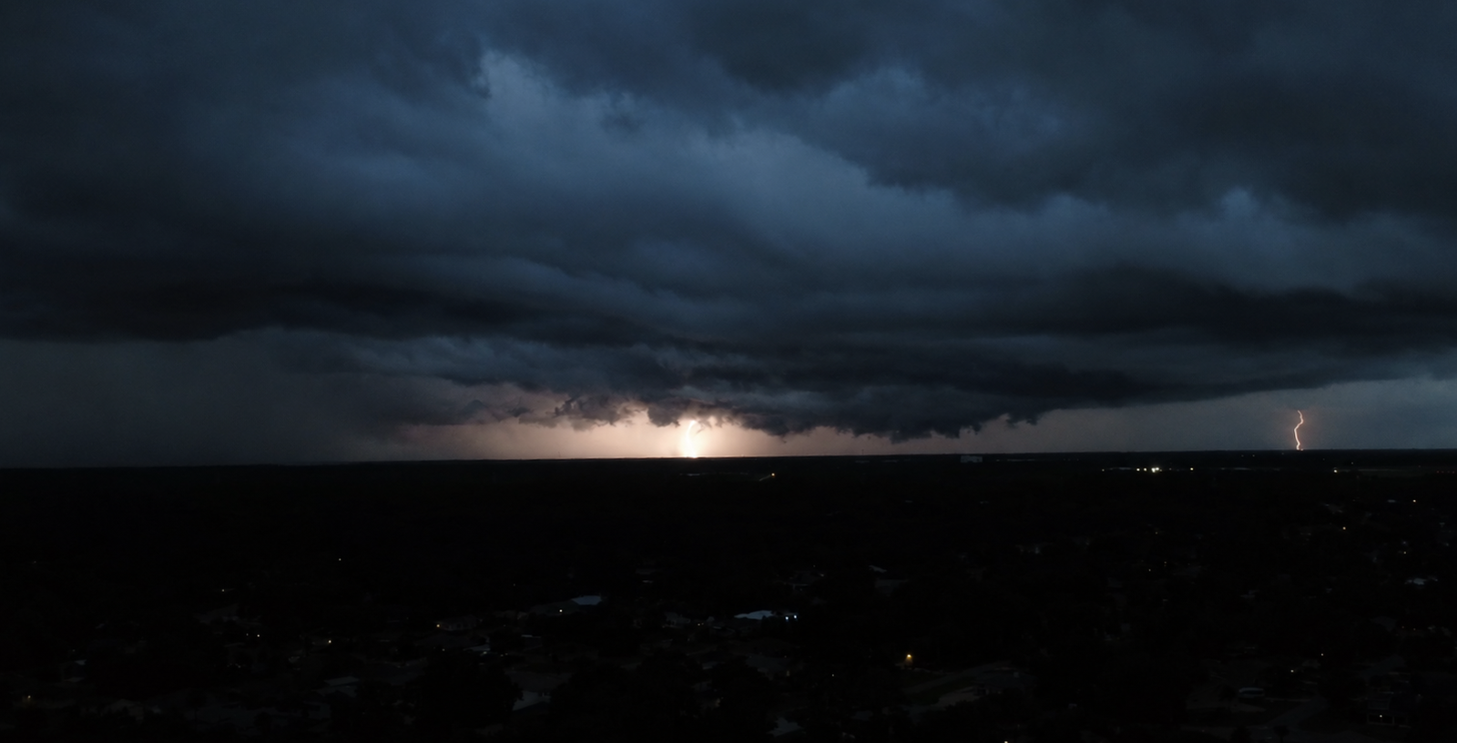Lightning beneath a dark storm over the Space Coast
